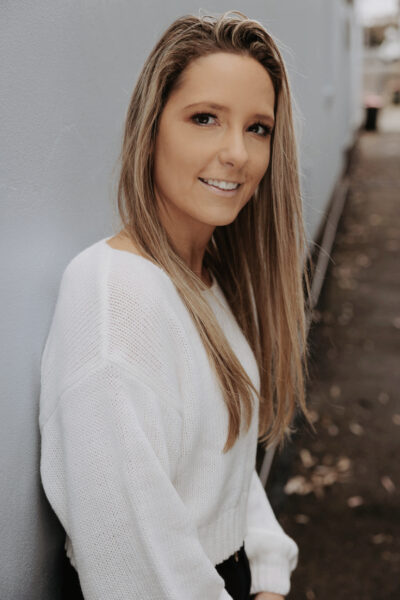 Image of Courtney Peppernell leaning againt wall.