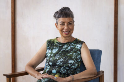 Michelle de Kretser photograhed sitting in her home.