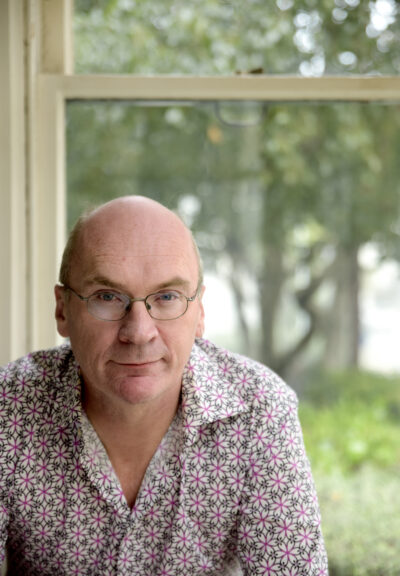 a portrait of Vincent O'Malley. He is bald and wears glasses.