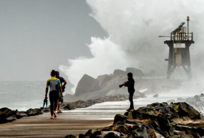 Three people on Newcastle waterfront.