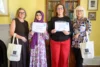 A photo of Kate Pickard, Zahina Maghrabi, Rebeca Green, and Gail Spiers. Maghrabi and Green hold certificates up.
