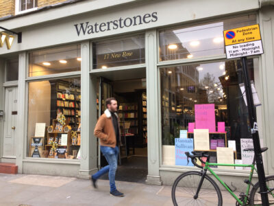 Photo of man walking past Waterstones store